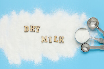 Dry vegan vegetable milk in powder on a blue background. Top View