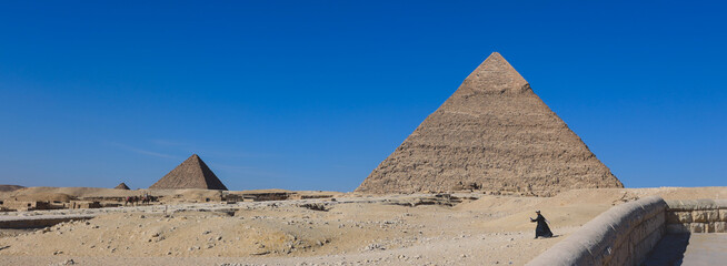 Natural View to the Great Pyramid of Giza under Blue Sky and Day Light - is the oldest and largest...