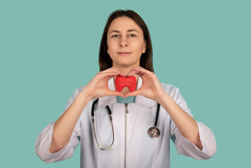 Female doctor with a stethoscope is holding mockup thyroid gland. Help and care concept