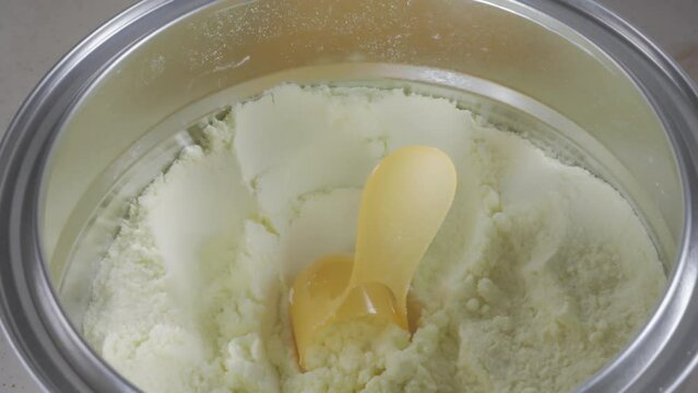 4K B-roll clips of preparing formula milk bottle for baby. Selective focus