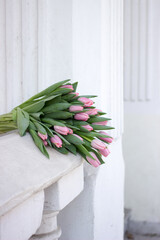 Gorgeous bouquet of tulips. Beautiful spring flowers. Gift for a girl. Arhitecture elements