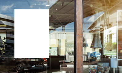 Mockup white paper or white sticker poster displayed on the front of the restaurant, coffee shop,...