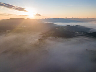 Obraz premium Sunrise over the fog in the Ukrainian Carpathians. Aerial drone view.