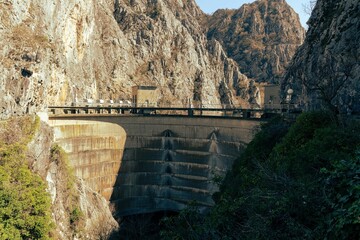 concrete wall of the dam at Matka canyon on Macedonia - obrazy, fototapety, plakaty