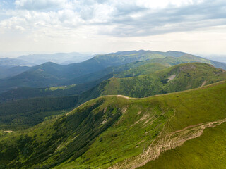 Naklejka premium High mountains of the Ukrainian Carpathians in cloudy weather. Aerial drone view.