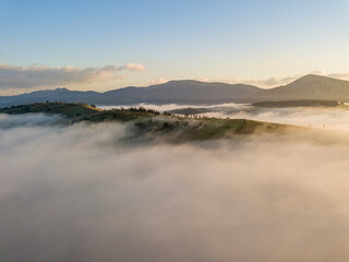 Morning fog in the Ukrainian Carpathians. Aerial drone view.