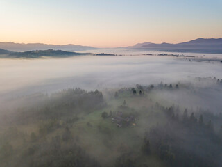 Sunrise over the fog in the Ukrainian Carpathians. Aerial drone view.