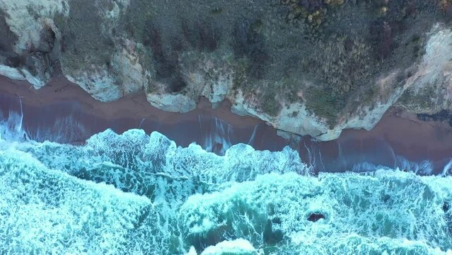 Aerial view to a beautiful wild rocky beach and big waves