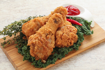 Fried chicken drumsticks with tomato sauce