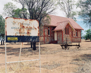 Close up shot of a church with a rusty and old signage