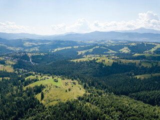 Naklejka na ściany i meble Green mountains of Ukrainian Carpathians in summer. Sunny day. Aerial drone view.