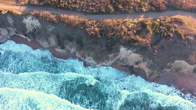 Aerial view to a beautiful wild rocky beach and big waves