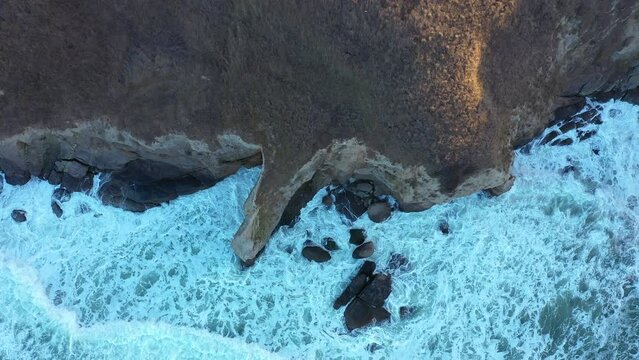 Aerial view to a beautiful wild rocky beach and big waves