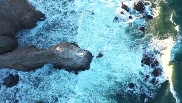 Aerial view to a beautiful wild rocky beach and big waves