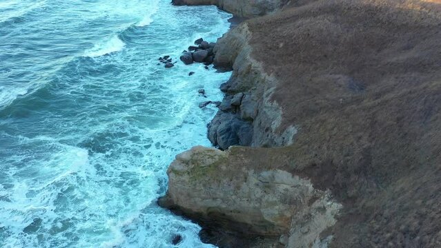 Aerial view to a beautiful wild rocky beach and big waves