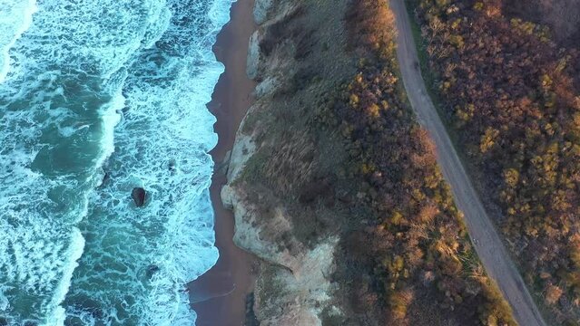 Aerial view to a beautiful wild rocky beach and big waves