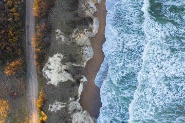 Aerial view to a beautiful wild rocky beach and big waves © niki spasov