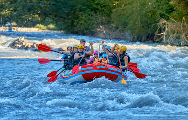 team is rafting on a large boat on the river