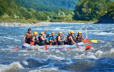 team is rafting on a large boat on the river - obrazy, fototapety, plakaty