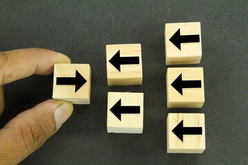 wooden cubes with arrows one in a different direction and another in a different direction