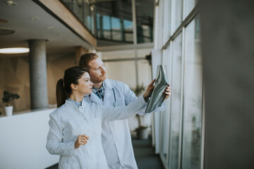 Team of young doctors examining x-ray image in the office