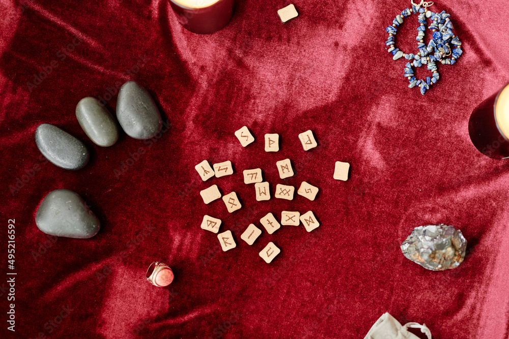 Wall mural top view background of runes and spiritual stones on red velvet table in fortune tellers shop, copy 