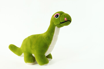 Cute plush dinosaur toy on a white isolated background.