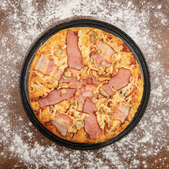 Big tasty pizza with ham meat and cheese