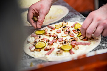 hand of chef baker making pizza at kitchen. The process of making pizza. cooking italian pizza