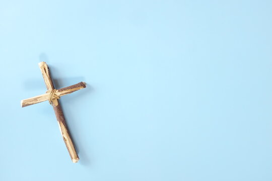Top view flat lay of wooden cross crucifix with copy space. Catholicism, Christianity, Catholic and Christian faith concept.