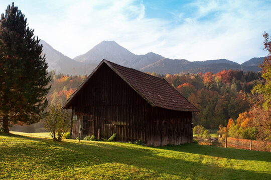 farm building against the backdrop of autumn mountains