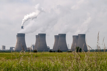 Nuclear power plant in central England. Chimneys of cooling towers from which smoke comes.