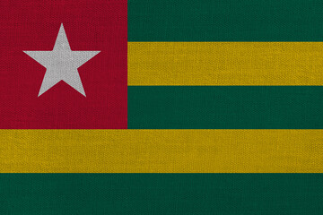 Patriotic textile background in colors of national flag. Togo