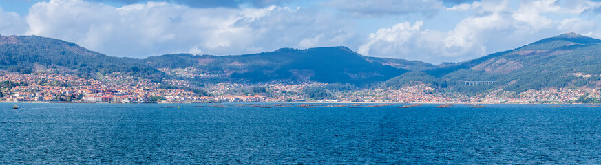 Naklejka na ściany i meble A panorama view from the cruise terminal across the Vigo estuary Spain on a spring day