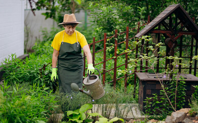 Portrait of a gardener woman working in her yard. The concept of gardening, growing and caring for...