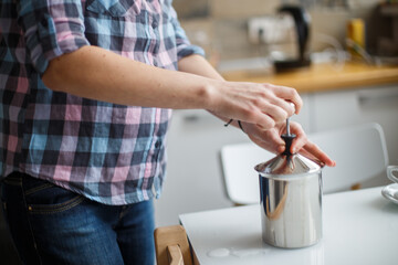 the girl is preparing morning coffee. the girl is preparing breakfast.