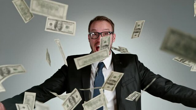 Super slow motion of screaming businessman with dollars. Filmed on high speed cinema camera, 1000 fps.