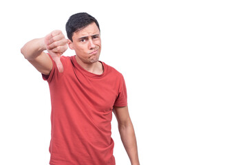 Sceptic guy giving thumb down gesture in studio