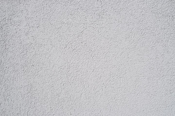 Obraz premium Pattern of grey rough sandy wall plaster as a background, closeup, details