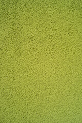 Pattern of green rough sandy wall plaster as a background, closeup, details