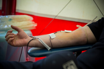 Man donating blood to save someone's life in hospital.