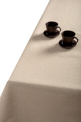 Beige tablecloth and pasuda on the table.