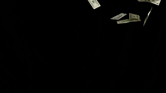Super slow motion of flying US dollars banknotes on black background. Filmed on high speed cinema camera, 1000fps. 