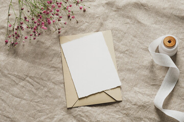 Still life summer wedding stationery, invitation card, envelope, silk ribbon, pink gypsophila...
