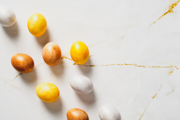 Elegant Easter flatlay composition. Luxury bronze Easter eggs on marble table. Flat lay, top view.