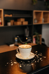 A cup of fresh coffee in coffee shop with blurred background