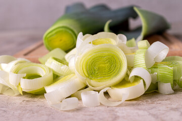 leek cut into slices on a wooden board, close-up