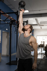 Obraz na płótnie Canvas man doing exercises with kettlebell in the gym