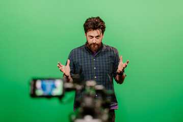 youtuber recording on green screen in studio