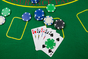 cards, chips lie on the green poker table.